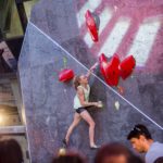 Female climber Lucia Dorfell competing on the natural stone boulder during Set & Send Boulder Comp in Sofia, Bulgaria