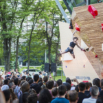 Female climber Cloe Coscoy competing on the bamboo boulder during Set & Send Boulder Comp in Sofia, Bulgaria