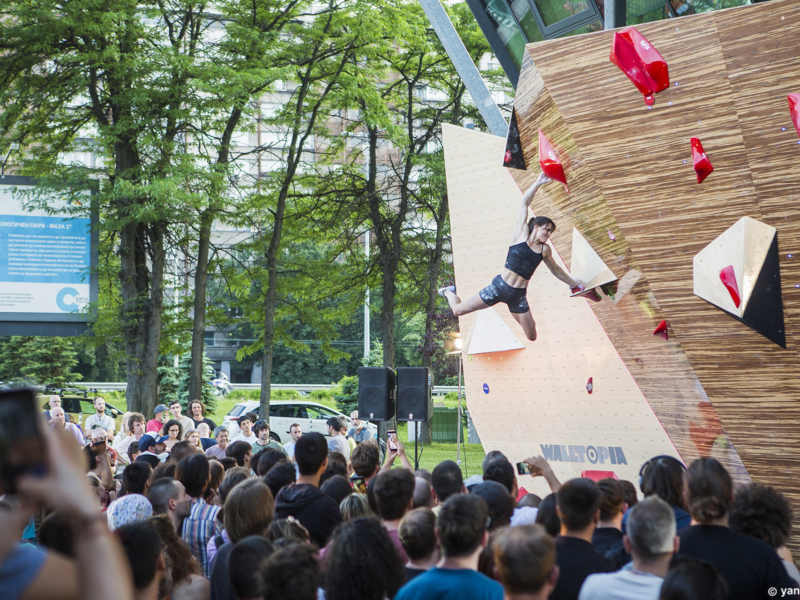 Female climber Cloe Coscoy competing on the bamboo boulder during Set & Send Boulder Comp in Sofia, Bulgaria