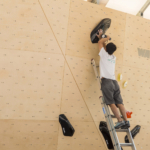 Tsukuru Hori route setting for Set'n'Send Boulder Comp on Walltopia natural wood boulder in Sofia, Bulgaria