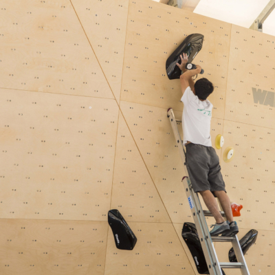 Tsukuru Hori route setting for Set'n'Send Boulder Comp on Walltopia natural wood boulder in Sofia, Bulgaria