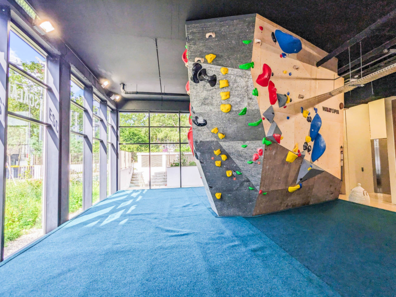 Walltopia boulder climbing walls in Granit Climb, France. Natural wood climbing panels combined with natural stone climbing panels and solid grey panels. Climbmat boulder mats.